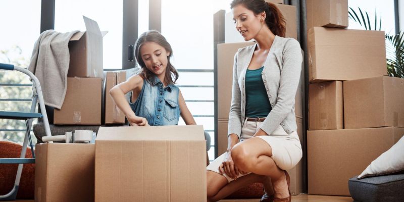 Child Helping a mother pack up for a move