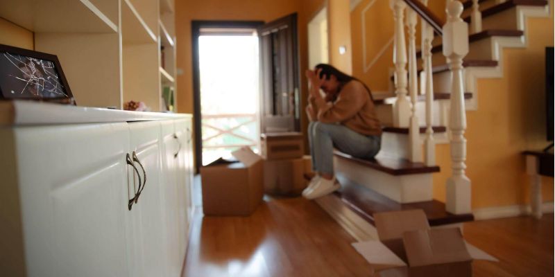 Woman sitting on a staircase, reflecting on divorce entitlements