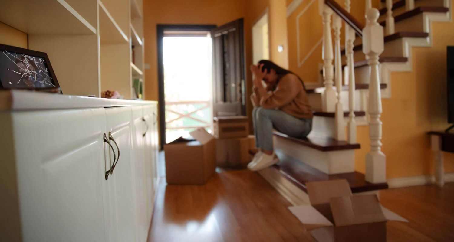 Woman sitting on a staircase, reflecting on divorce entitlements