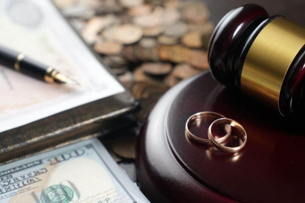a judge's gavel with two wedding rings on top of it