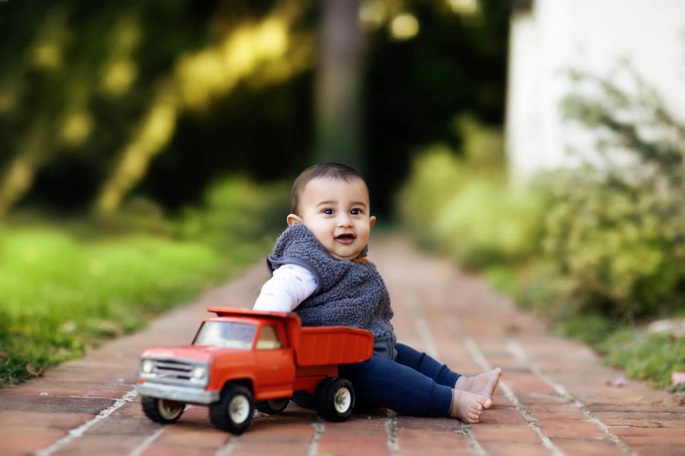 child playing with toy truck