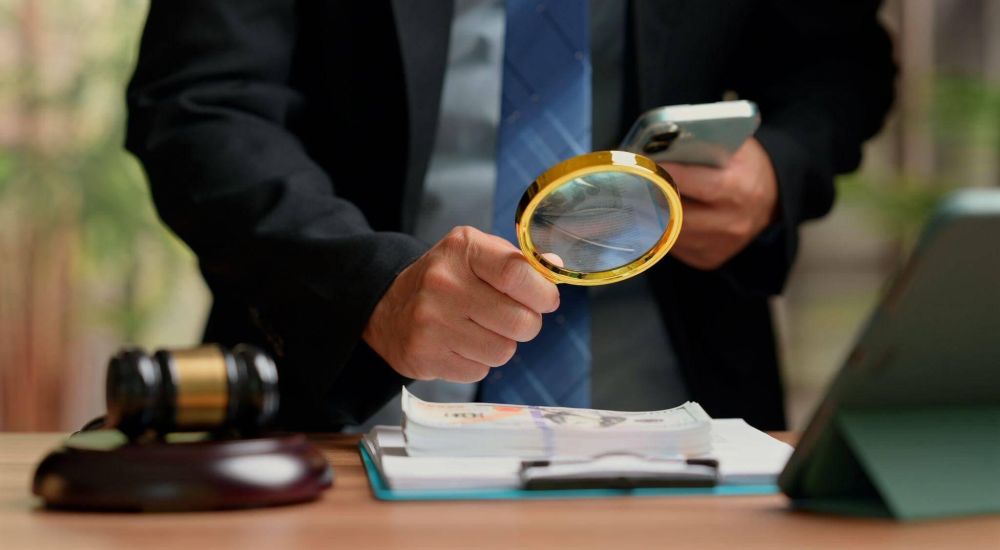 Forensic accountant with magnifying glass for