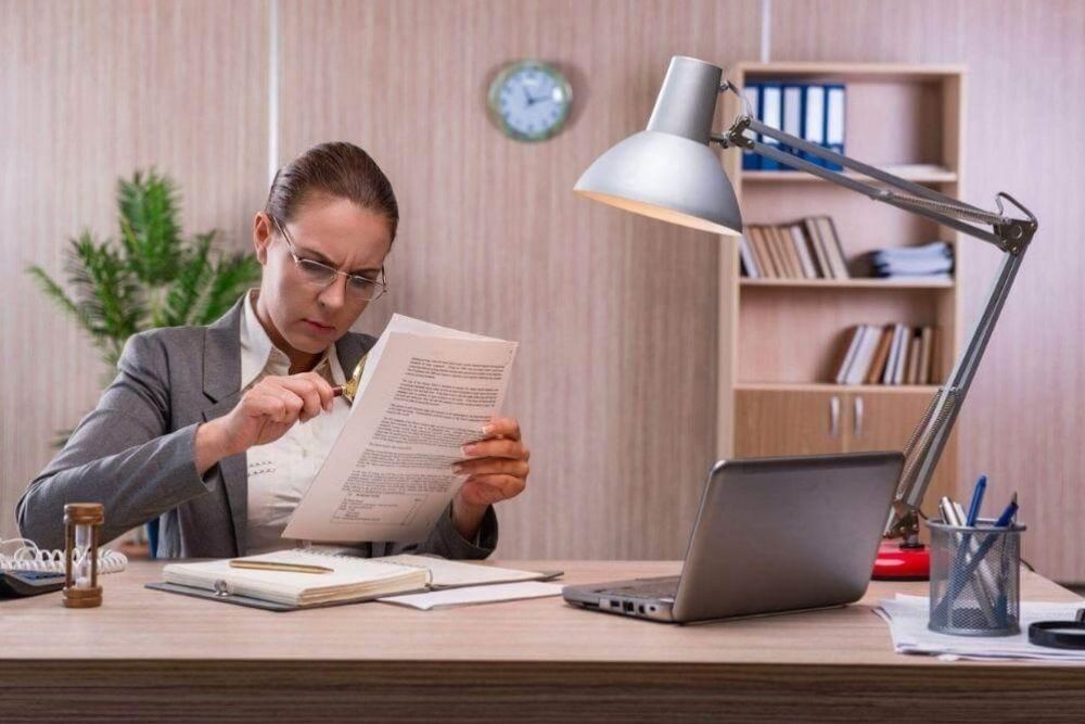 Woman reviewing documents, possibly related to