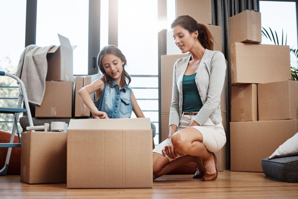 Child Helping a mother pack up for a move