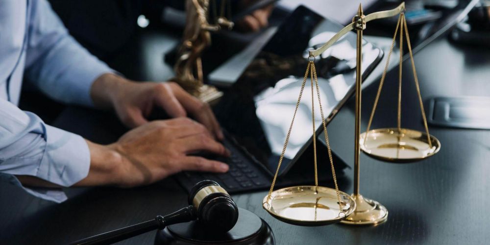 Northern Virginia divorce lawyer reviewing case at desk with scale
