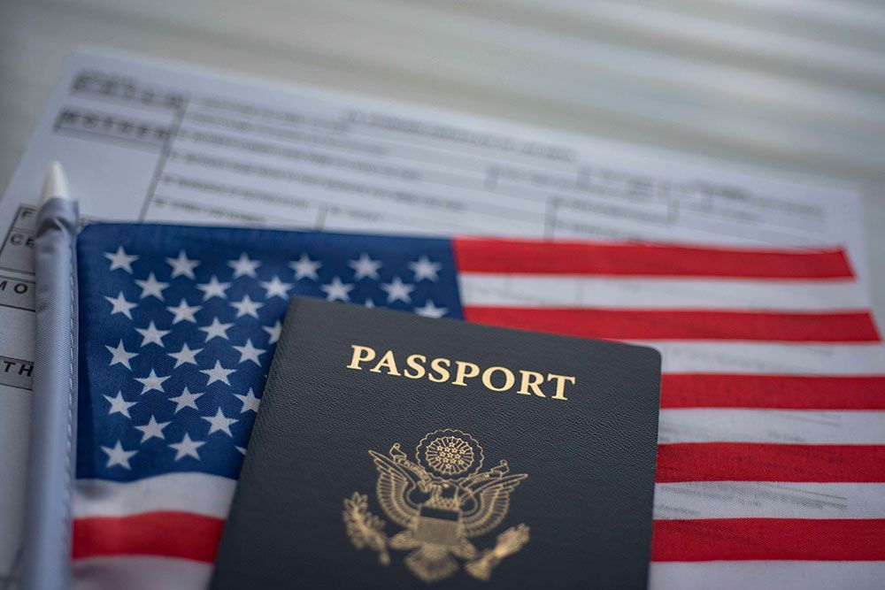 The American flag with a passport on top of it represnting immigration rights in America