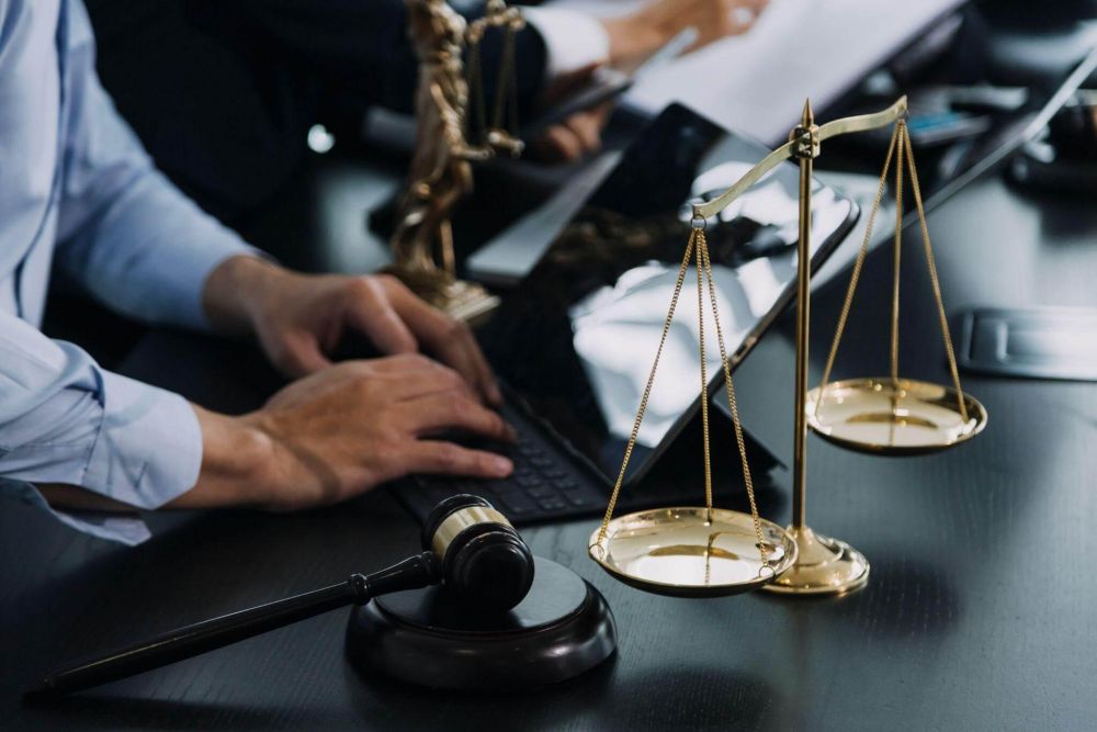 Northern Virginia divorce lawyer reviewing case at desk with scale
