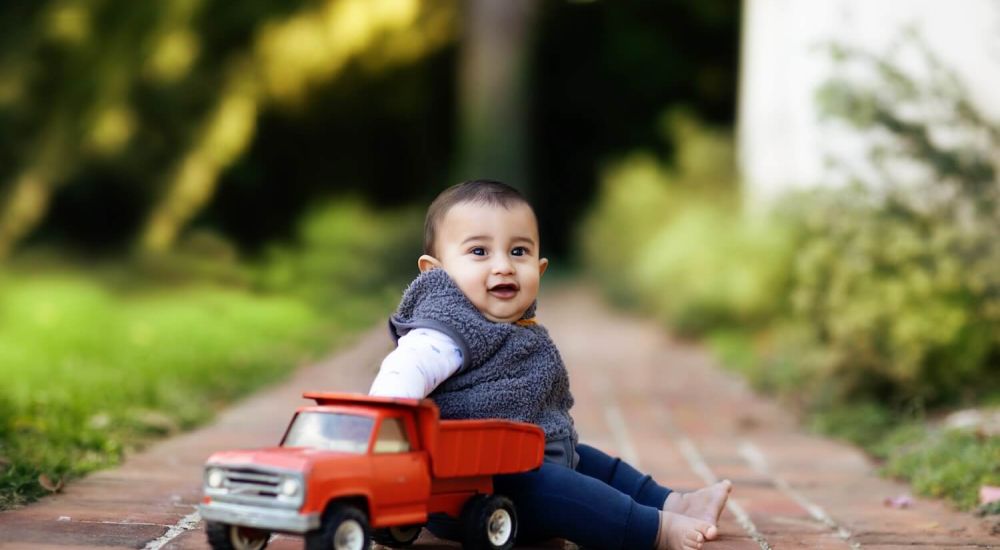 child playing with toy truck