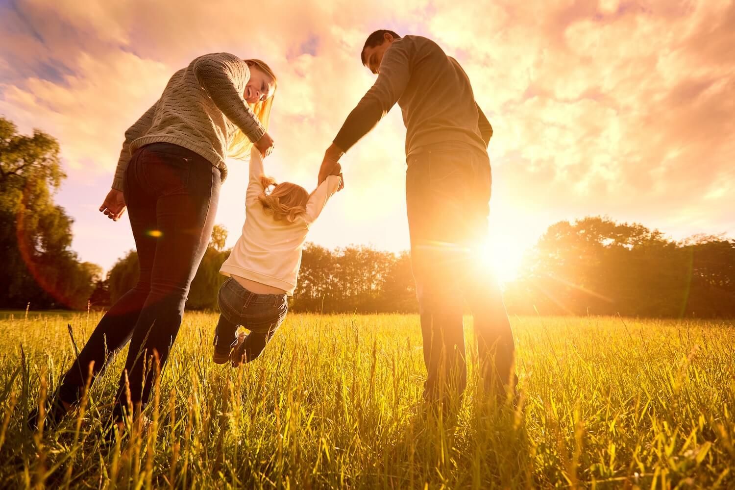 happy family playing in field