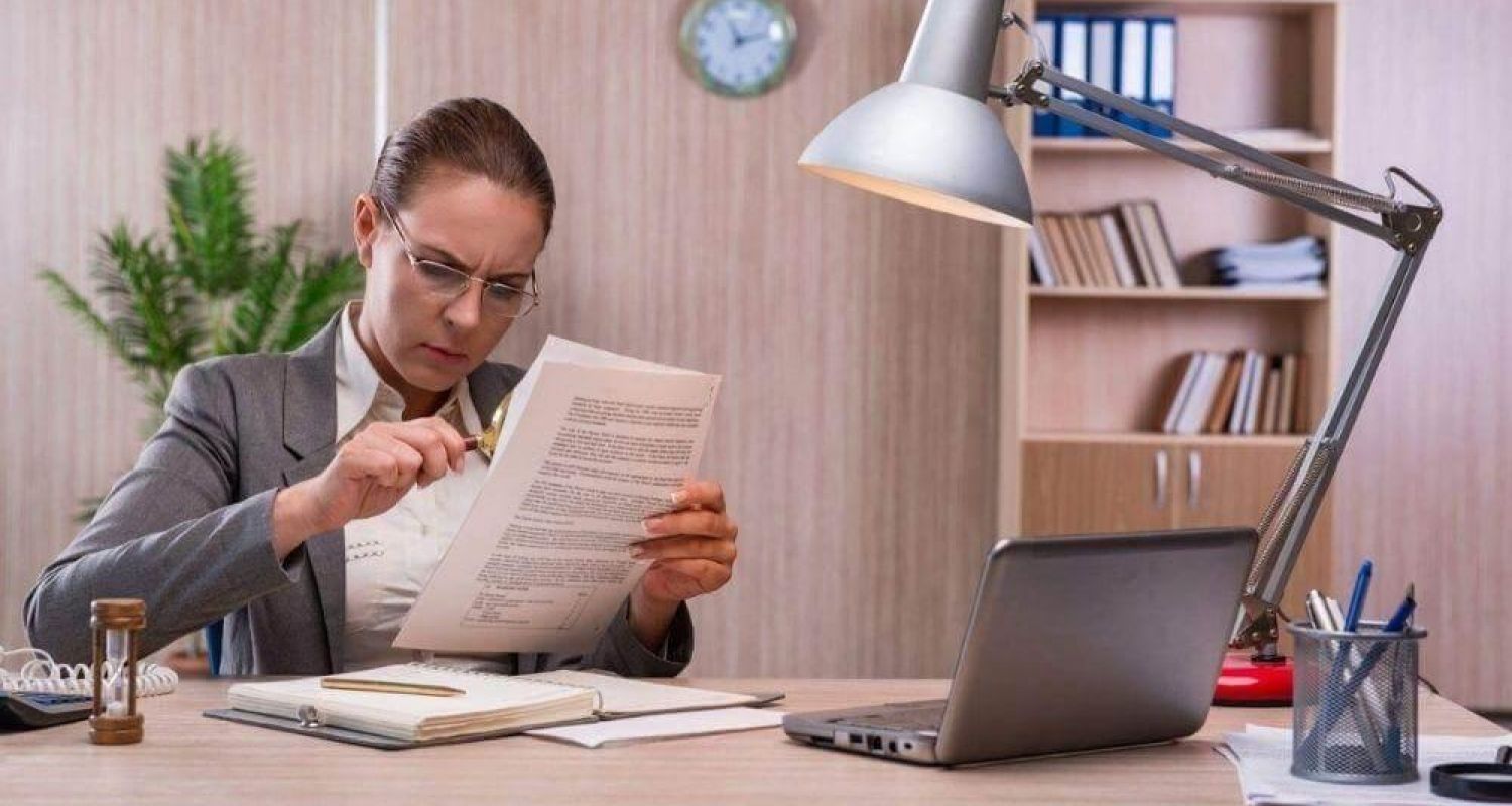Woman reviewing documents, possibly related to