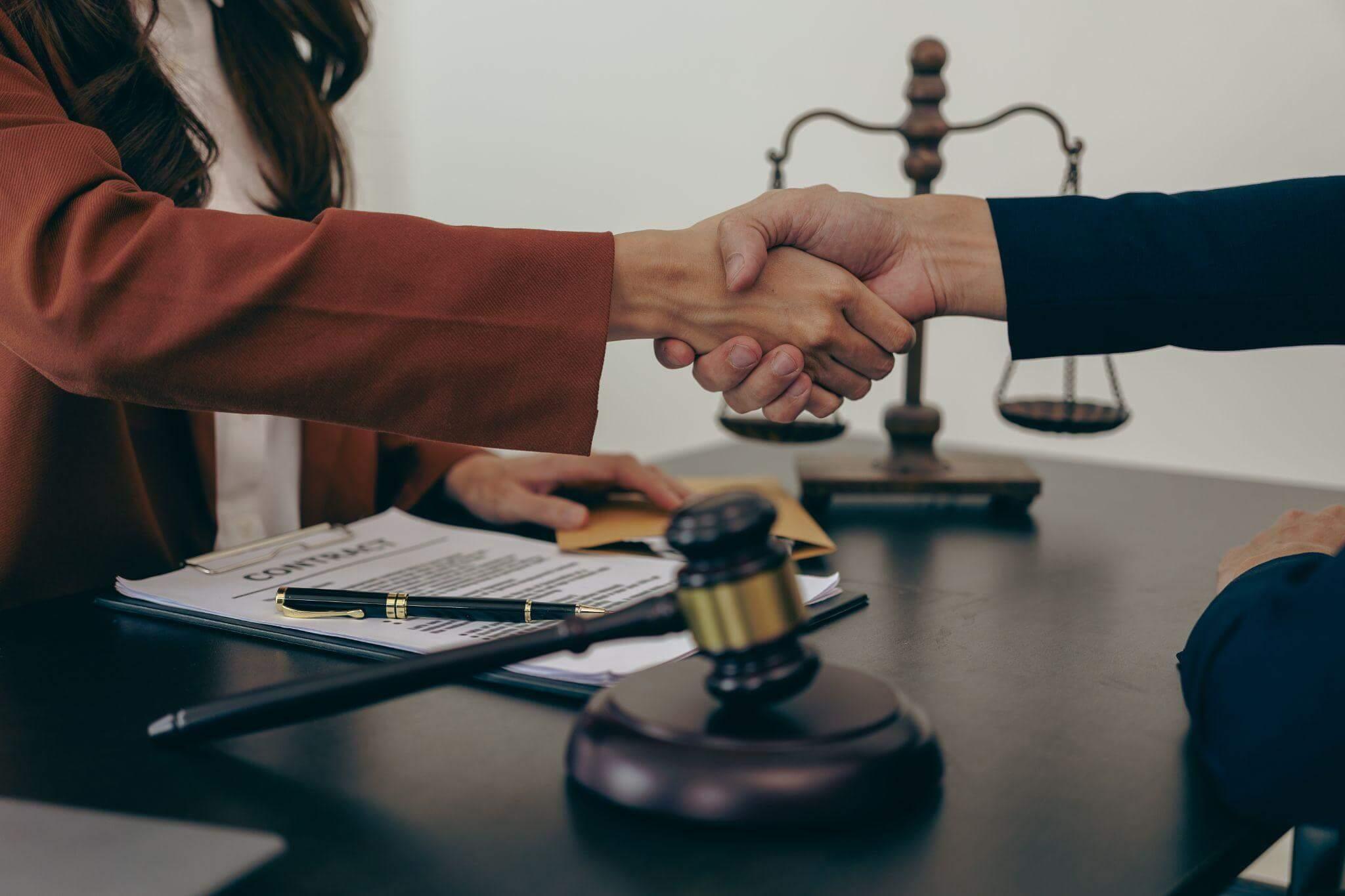 Couple shaking hands over a divorce agreement in Virginia