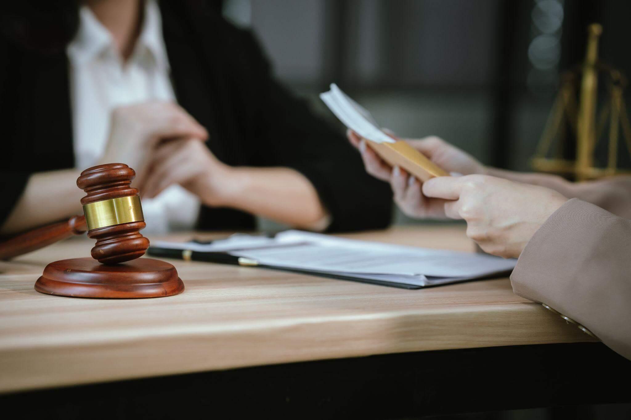 Two people at a table with a judge