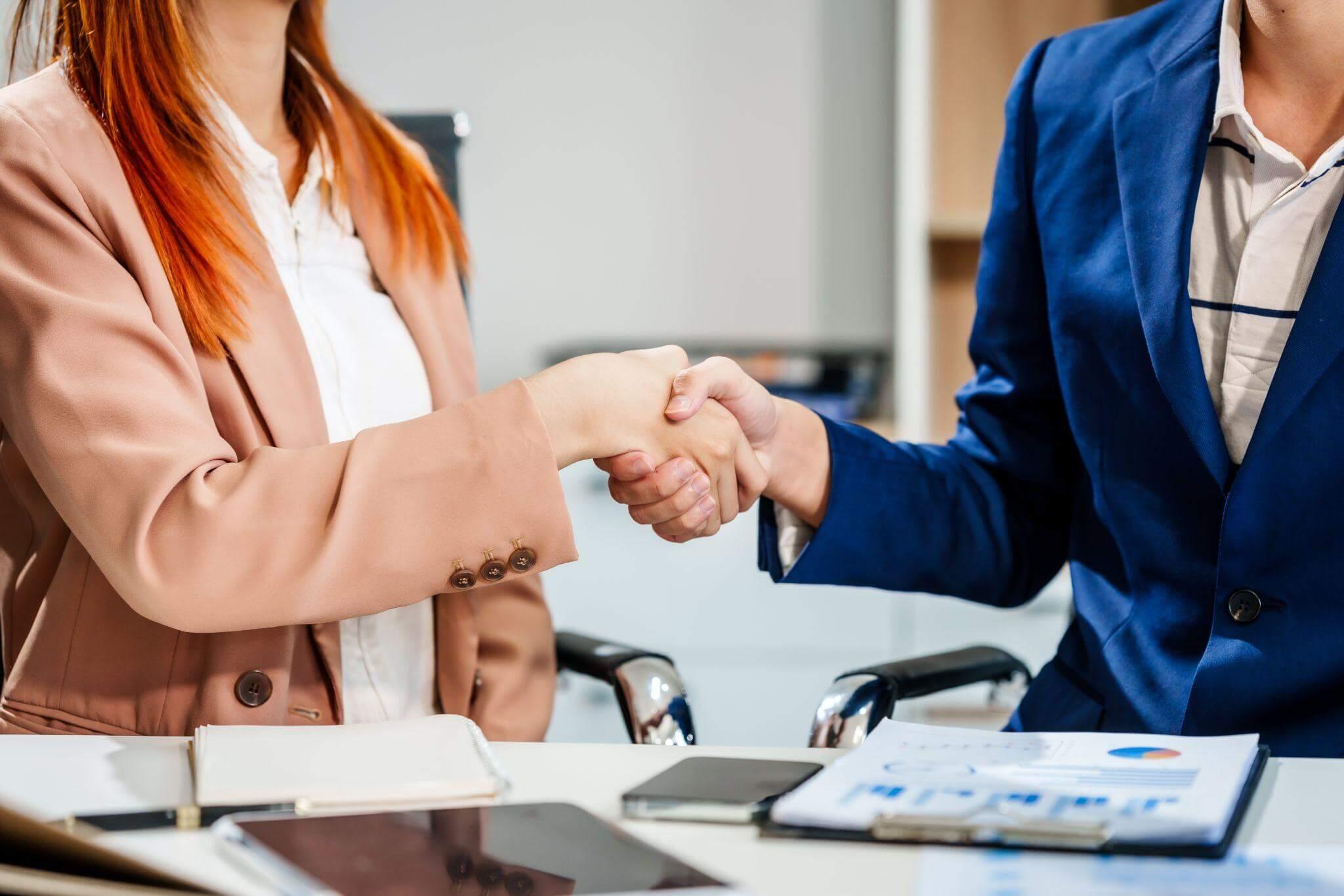 Man and woman shaking hands, agreeing on high net
