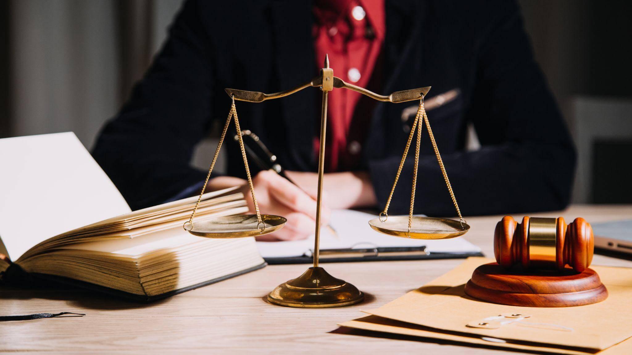 Person reviewing documents with a scale, representing divorce forensic